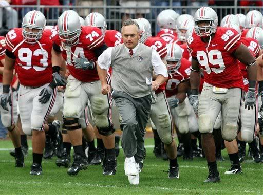 Ohio State football coach Jim Tressel, center, leads his team on the field during the second half against Penn State, Saturday, Sept 23, 2006, in Columbus, Ohio