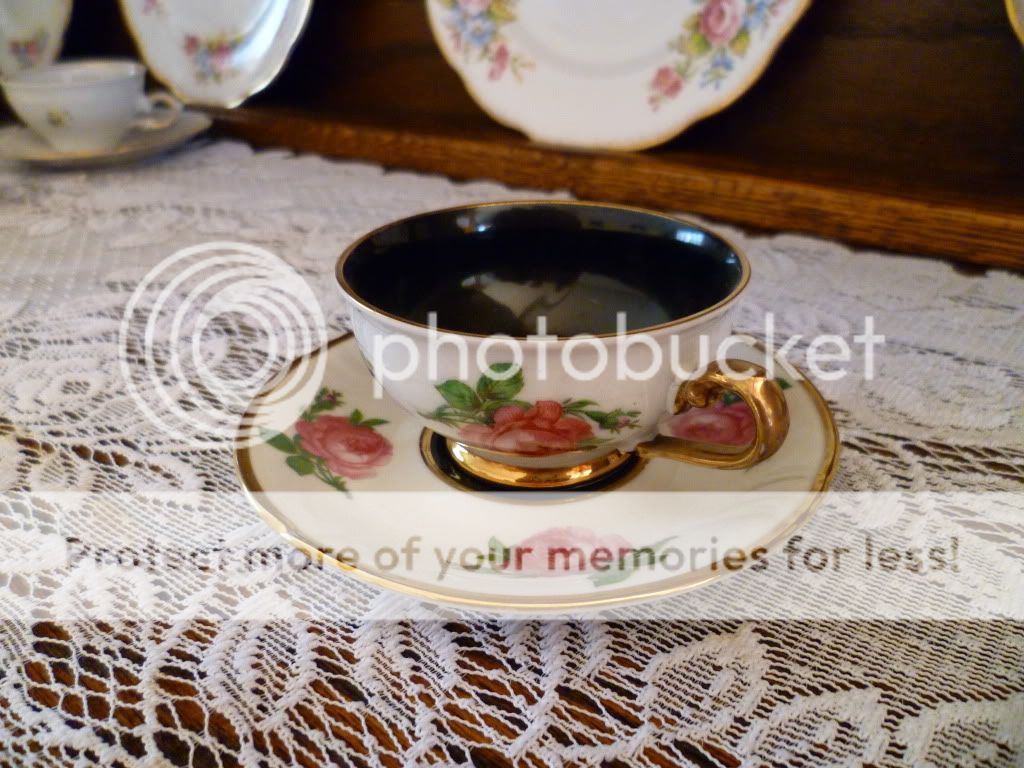 this lovely cup saucer are detailed with dark pink roses and trimmed 